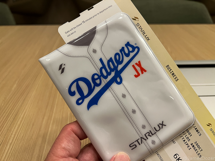 a hand holding a white plastic case with blue text