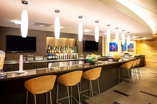 a bar with chairs and a television