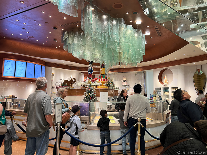 people standing in a room with a glass display case