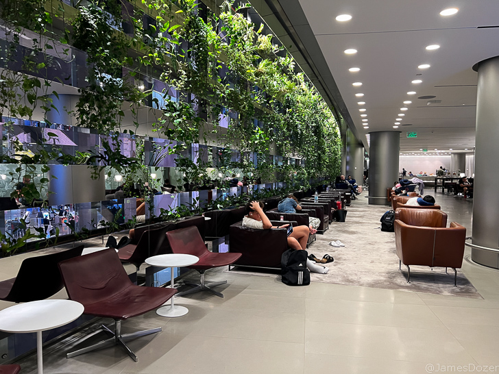 people sitting in chairs in a lobby