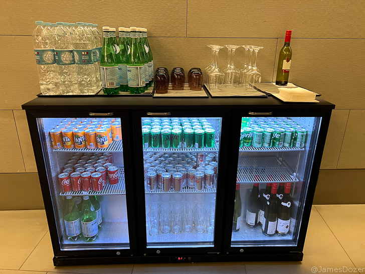 a refrigerator with drinks and glasses