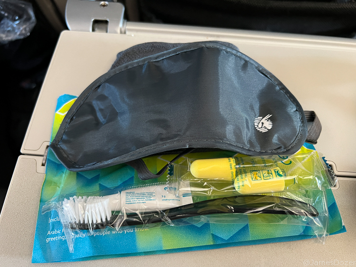 a sleeping bag and a mask on a plane