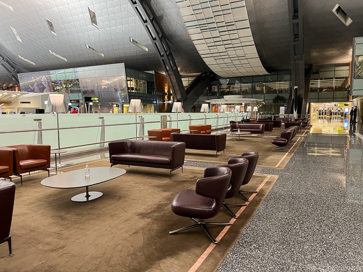 a lounge area with chairs and tables