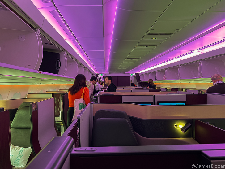people in an airplane with purple lights