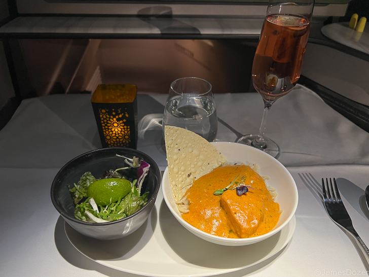 a plate of food and a glass of wine