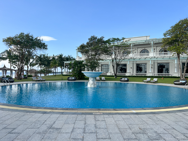 a pool with a fountain in the middle of it