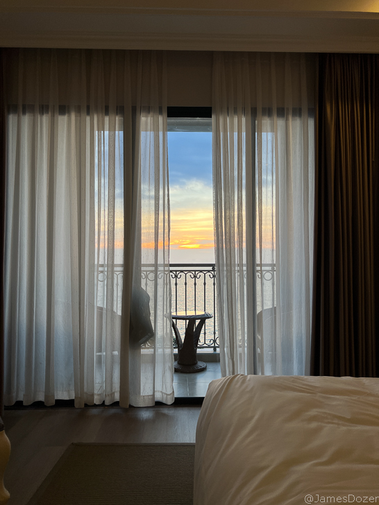a room with a balcony and a table with a table and chairs