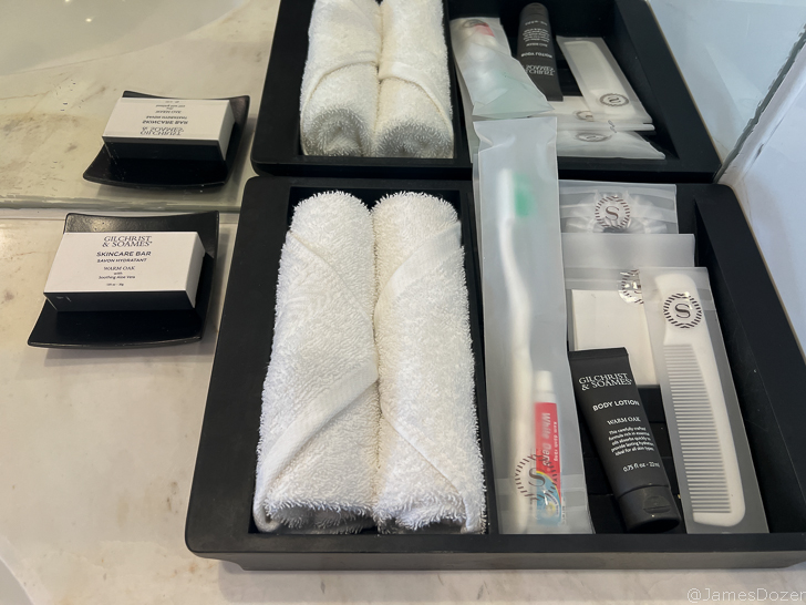 a black tray with white towels and other items