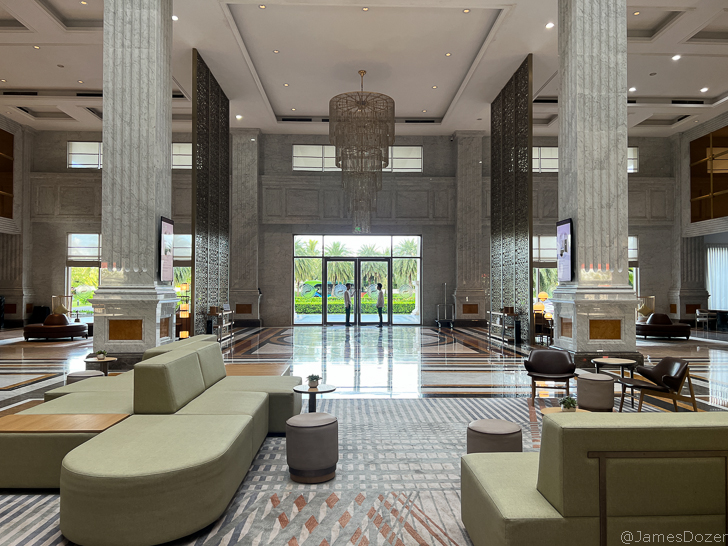 a large lobby with a chandelier and chairs