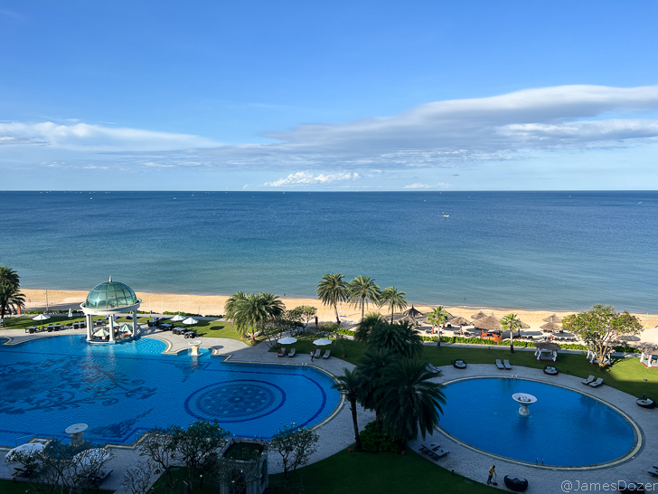 a pool and a beach with palm trees