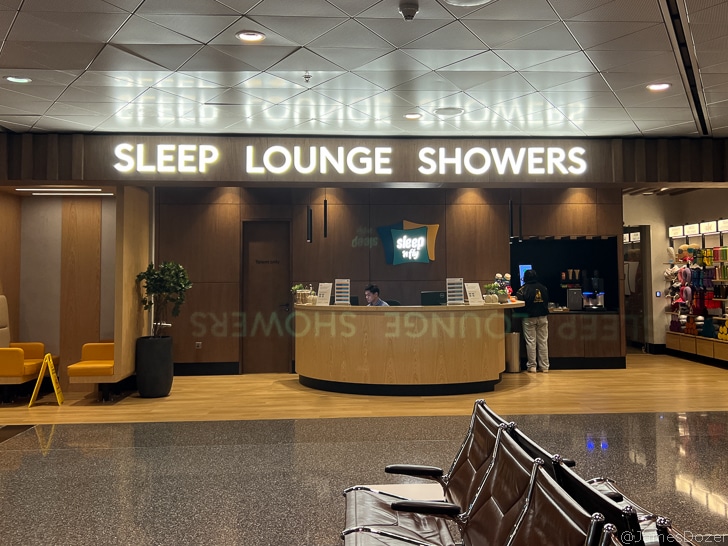 a lounge area with a man at the counter