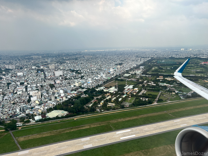 an airplane wing and a city