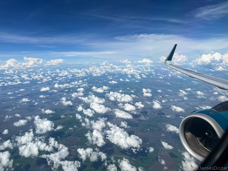 an airplane wing and clouds