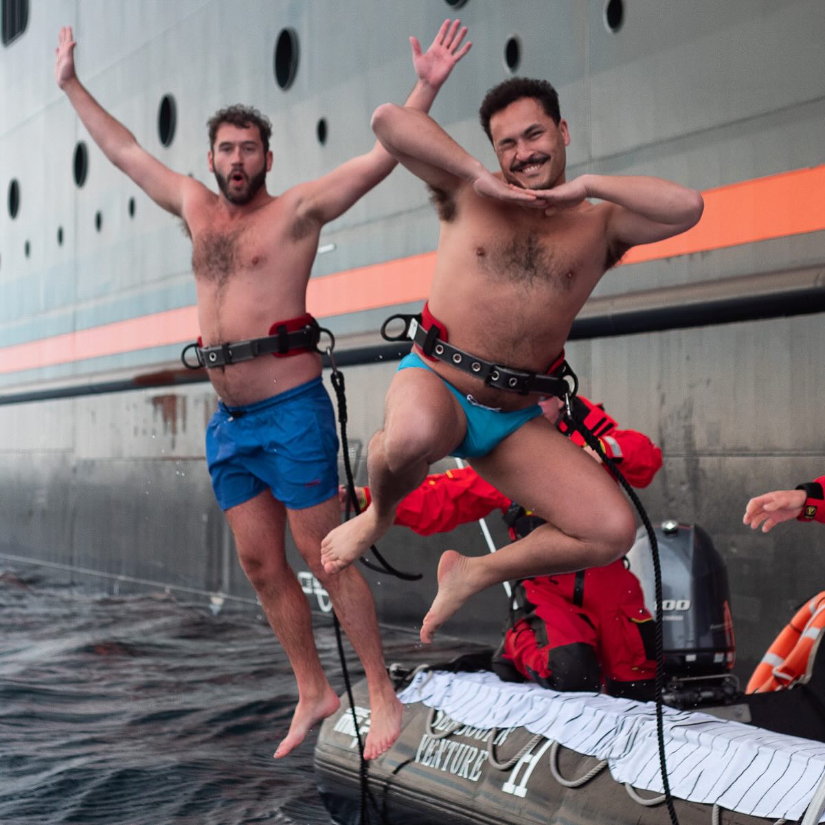 two men jumping into the water