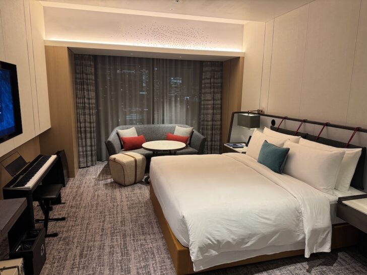 a room with a bed and a piano