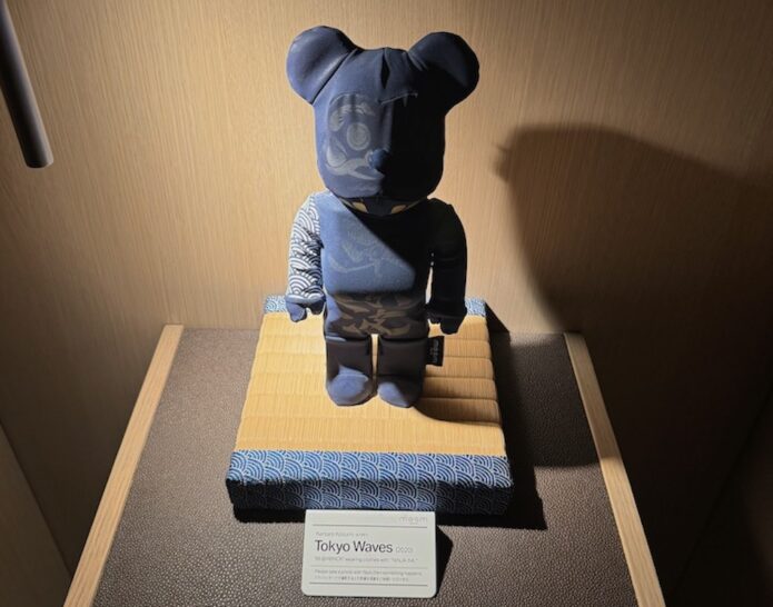 a stuffed bear doll on a mat