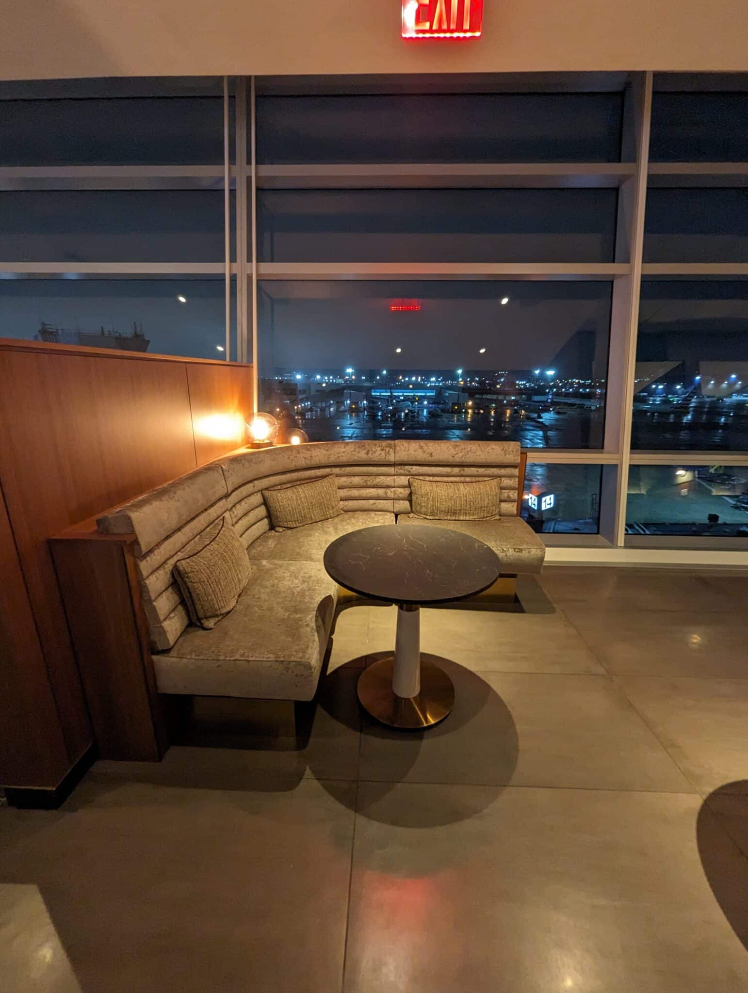 a couch and table in a room with a view of a city
