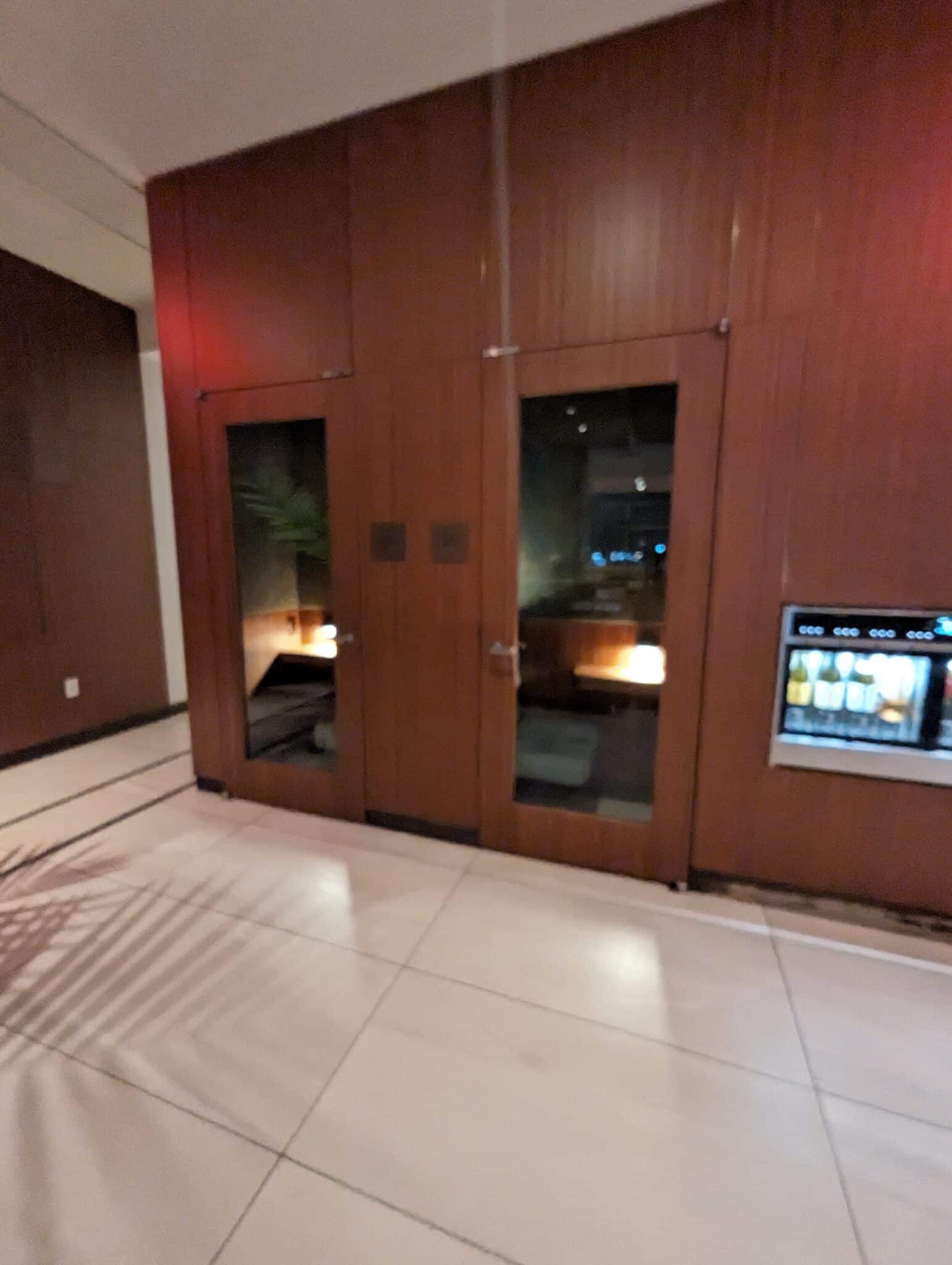 a room with a door and a vending machine