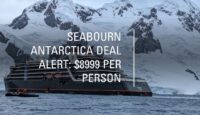 a ship in the water with mountains in the background