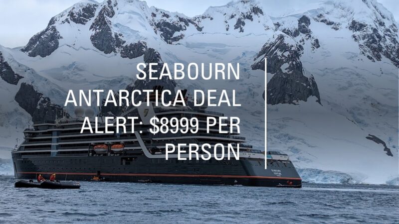 a ship in the water with mountains in the background