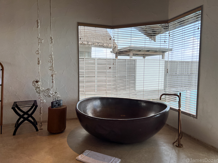 a large round bathtub in a corner of a room