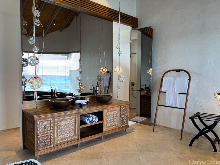 a bathroom with a large mirror and a sink