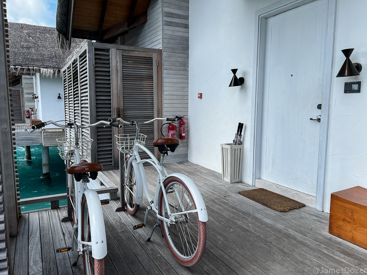 a white bicycles parked on a deck