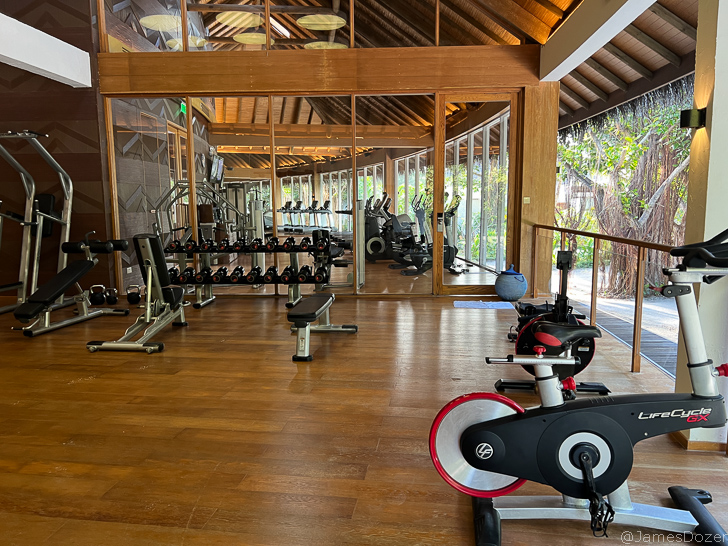 a room with exercise bikes and a large window