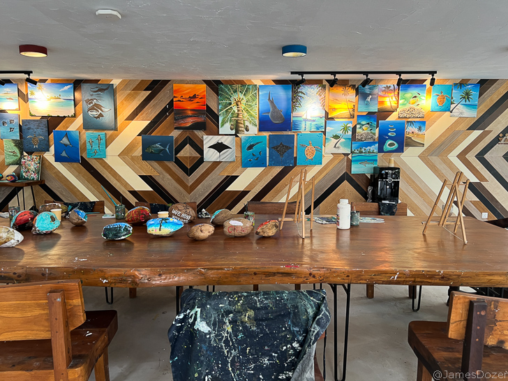 a table with paintings on the wall