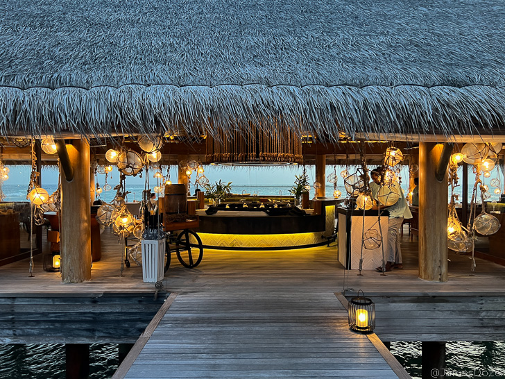 a deck with a bar and lights