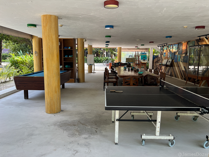 a pool table and ping pong table in a room