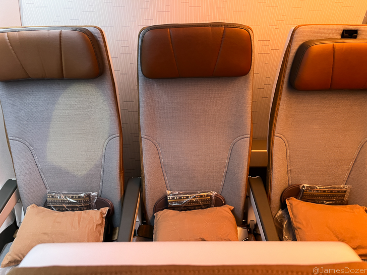 a row of chairs with pillows