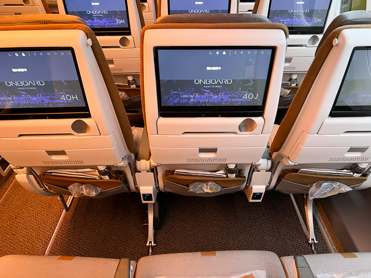 a row of seats with a screen on the back