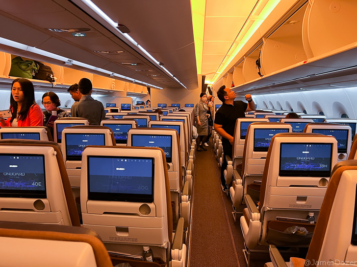 a row of seats with monitors on the side