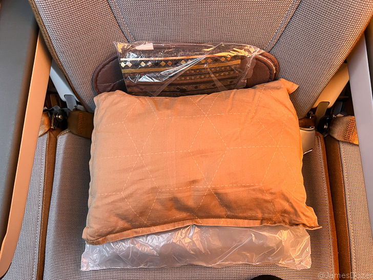 a pillow and a plastic bag on a seat