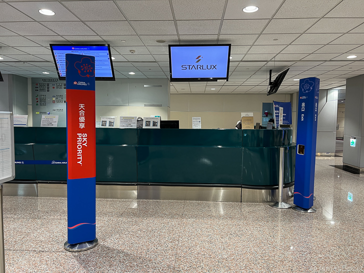 a blue and red post with screens in front of a reception desk