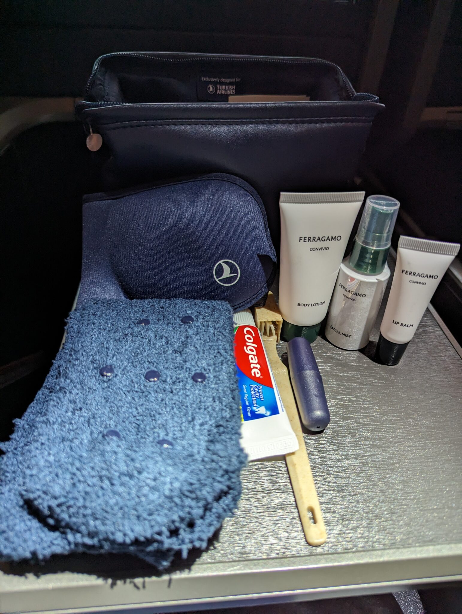 a blue towel and a bag with other items on a table