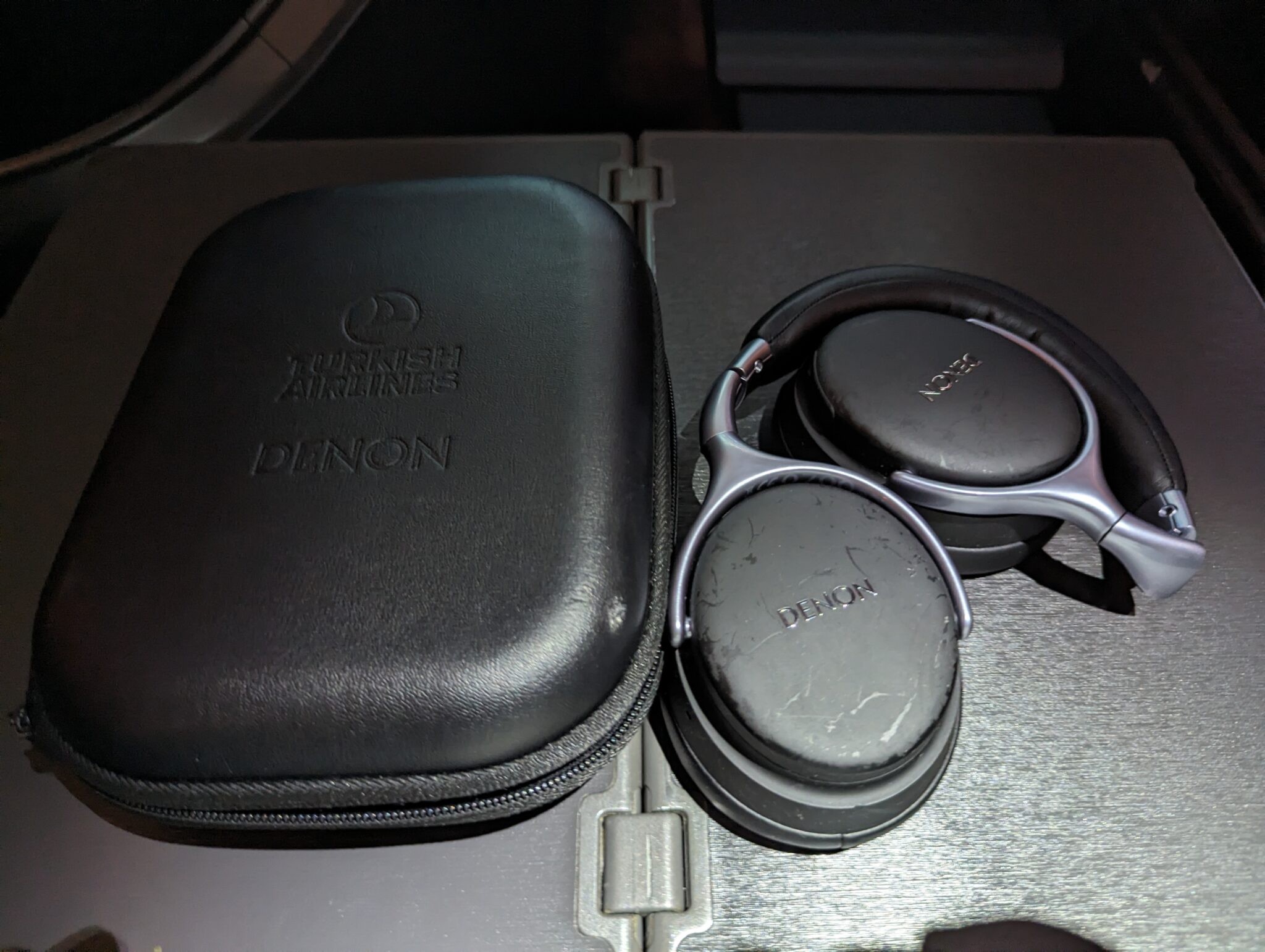 a pair of headphones next to a case