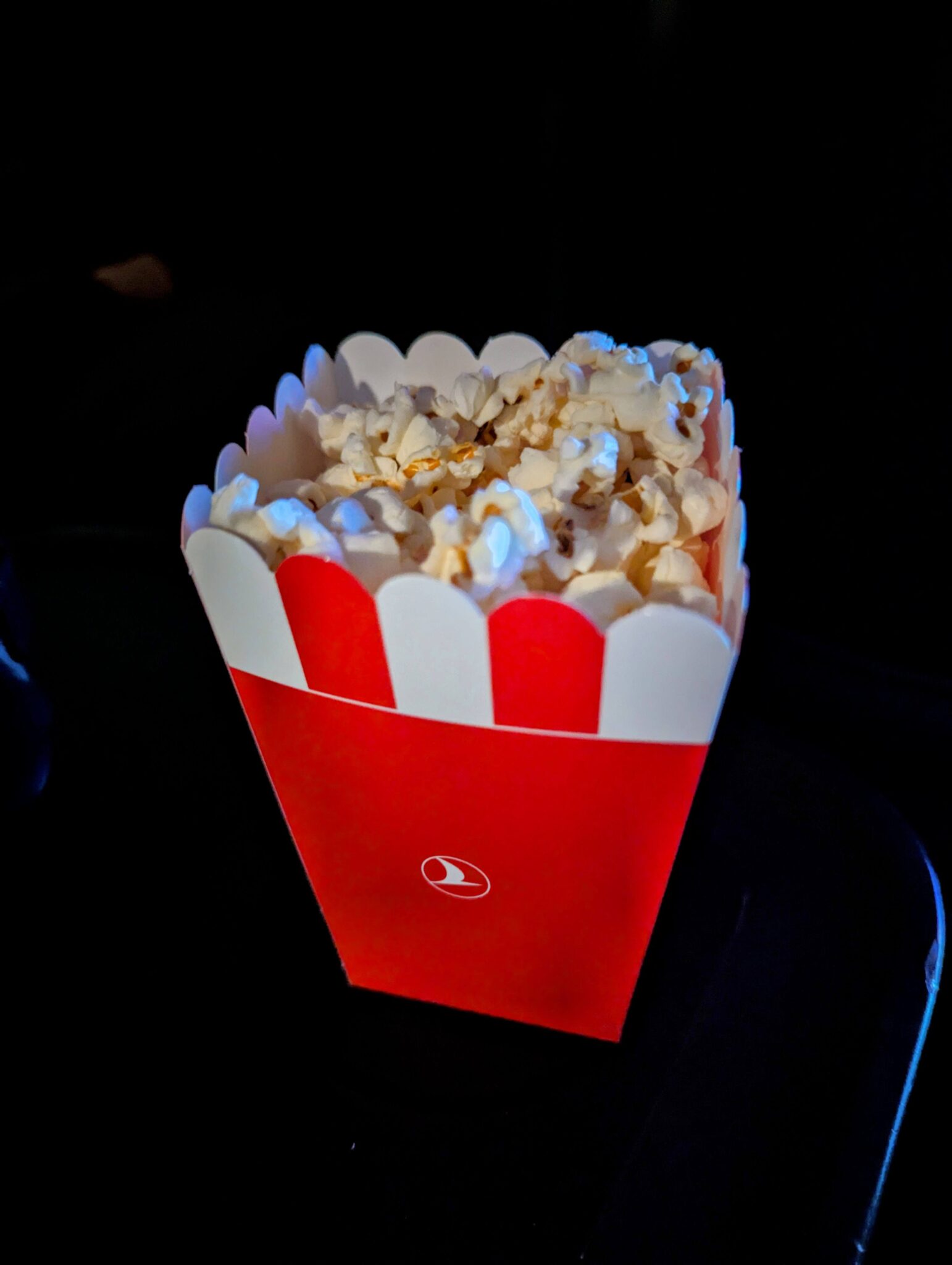 a red and white box of popcorn