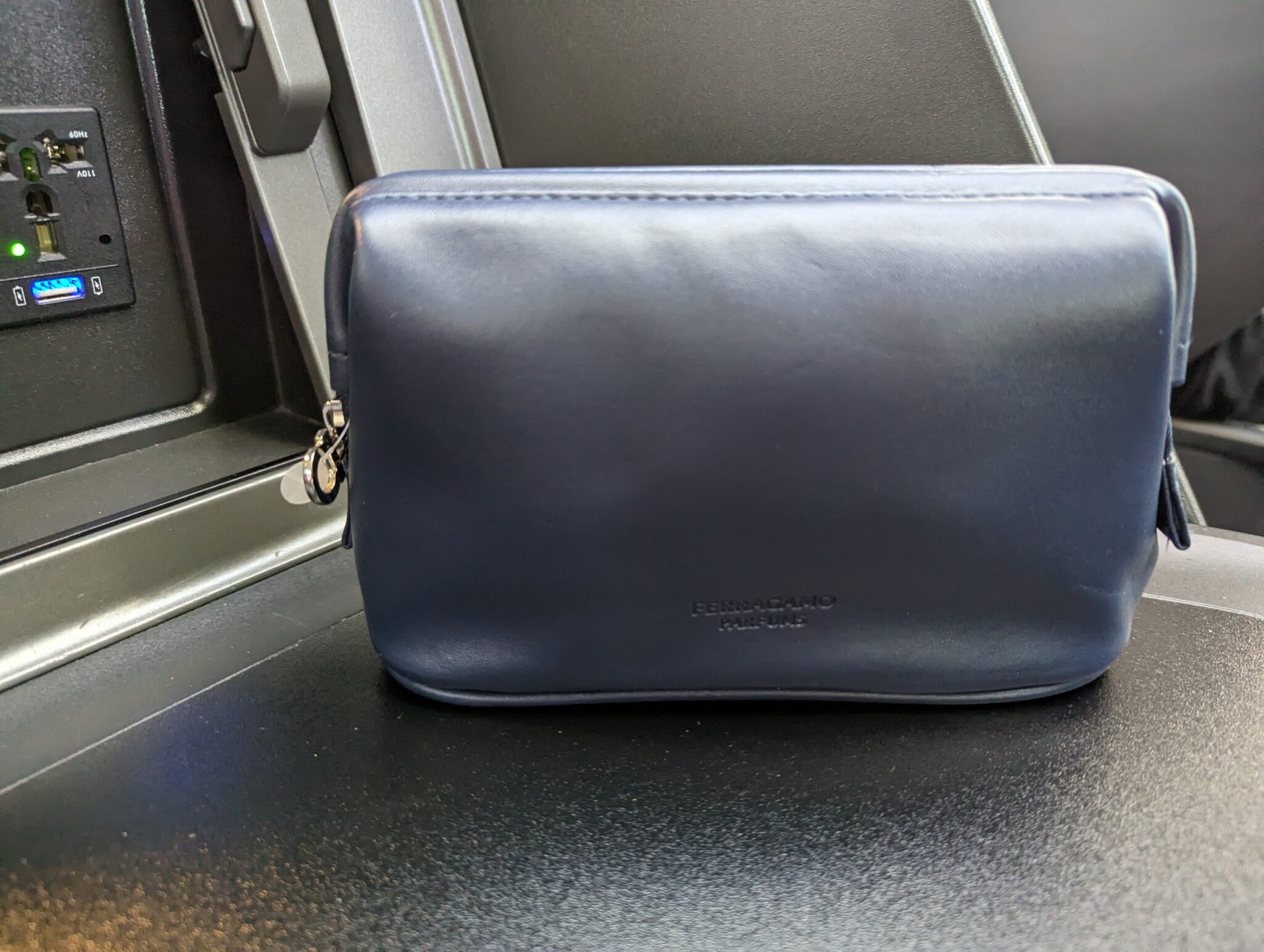 a blue leather bag on a black surface
