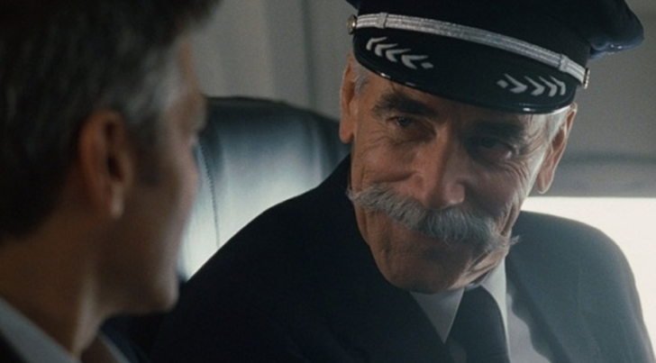 a man in a uniform and hat