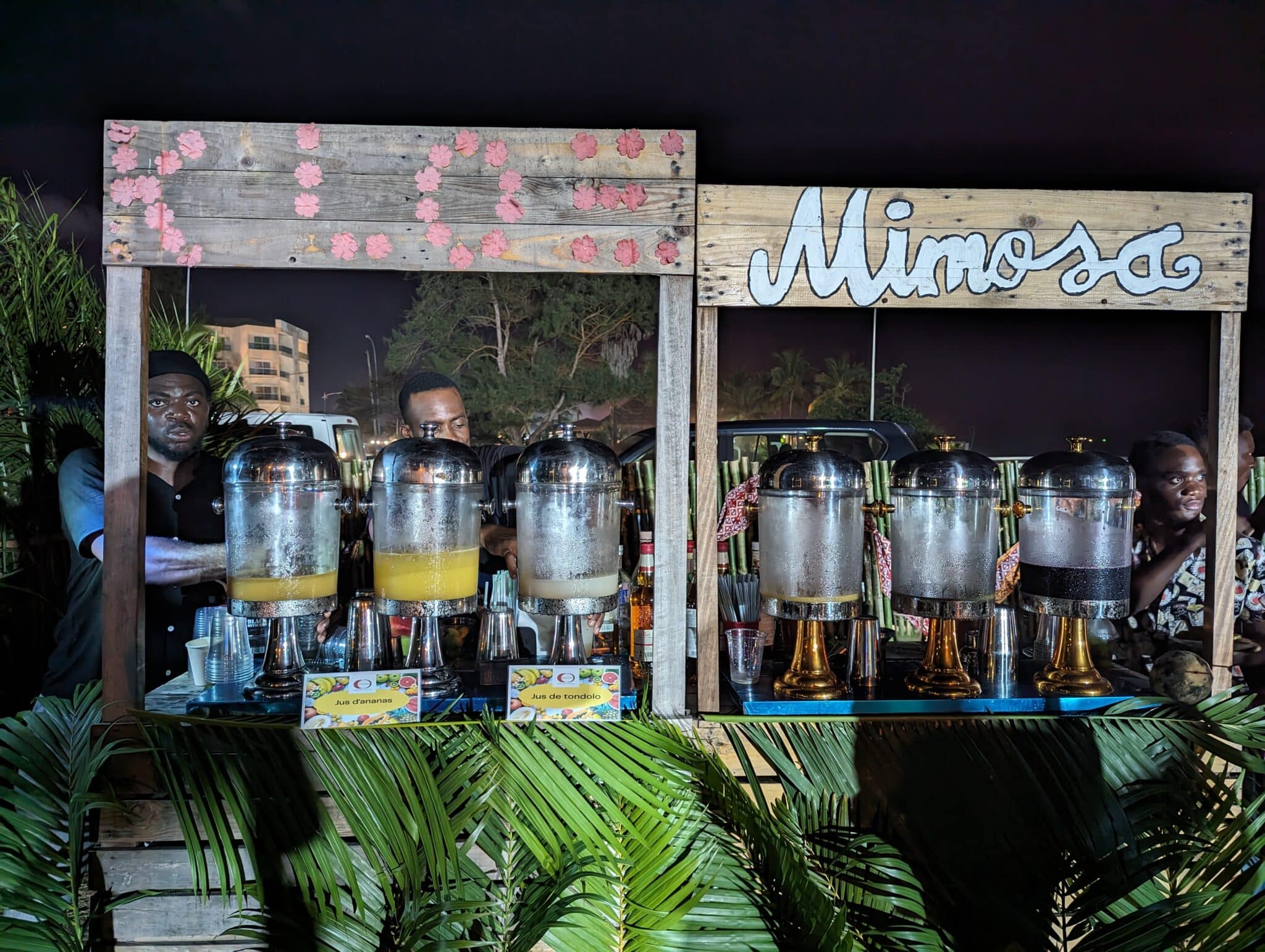 a man standing behind a table with drinks