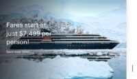 a ship in the water with snow and mountains in the background