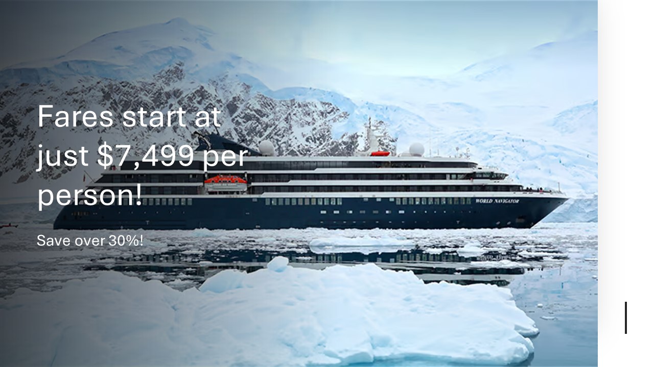 a ship in the water with snow and mountains in the background