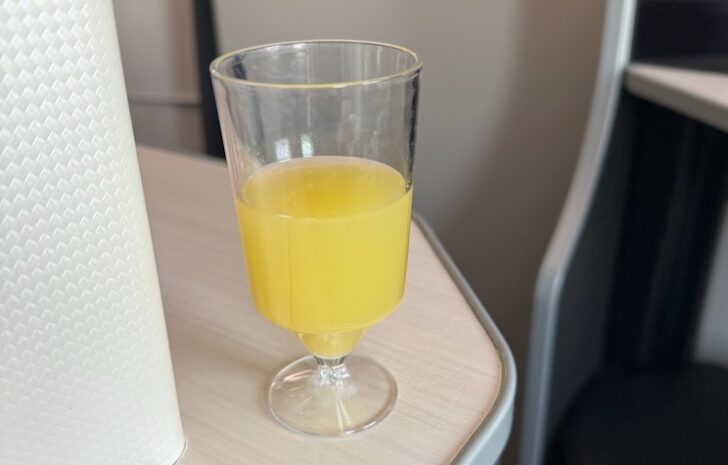 a glass of orange juice on a table