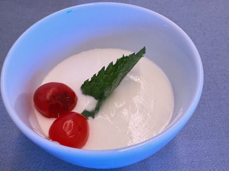 a bowl of food with a leaf