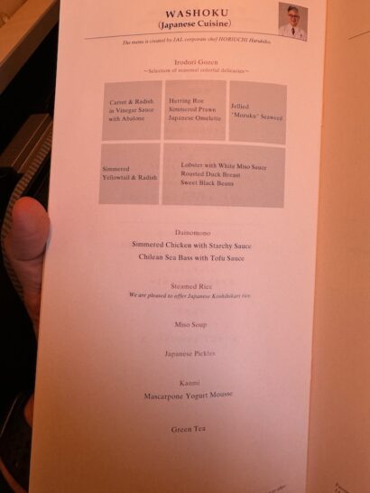 a hand holding a menu