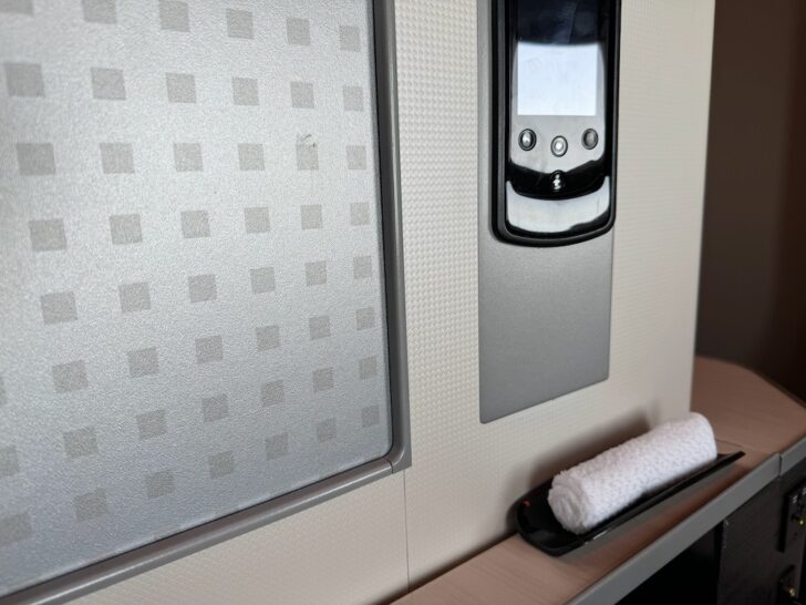 a towel on a tray next to a phone