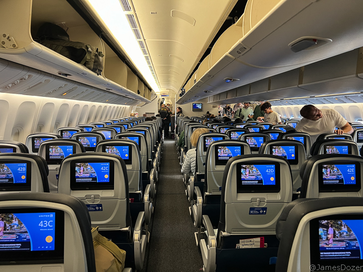 a row of seats with monitors on the side