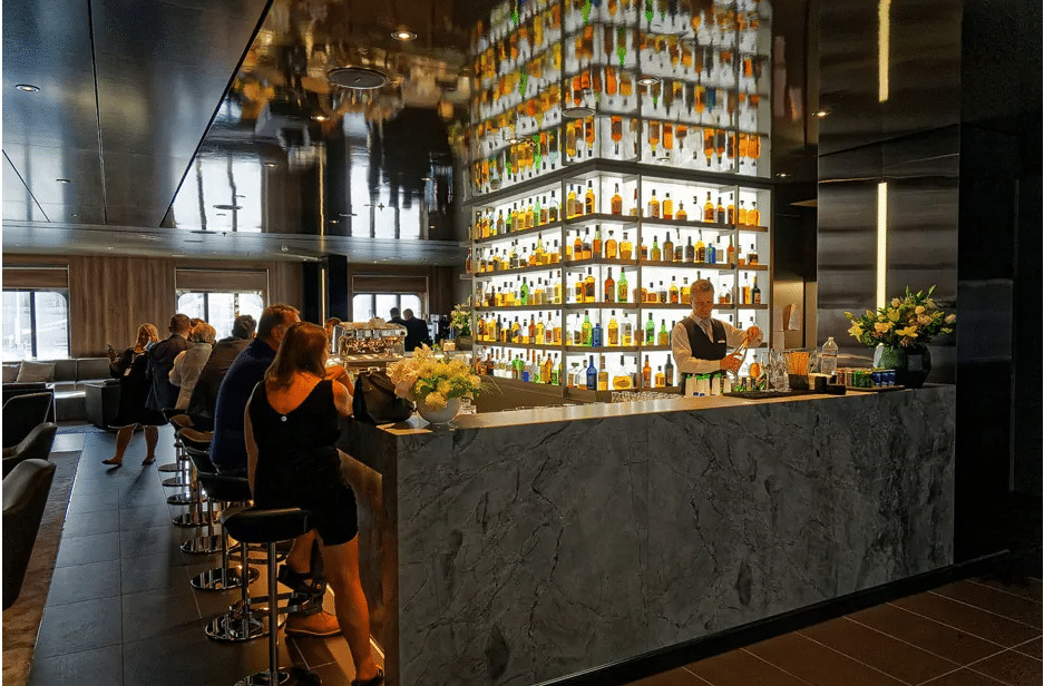 scenic eclipse whiskey bar a bar with a man standing behind a counter with bottles on the wall